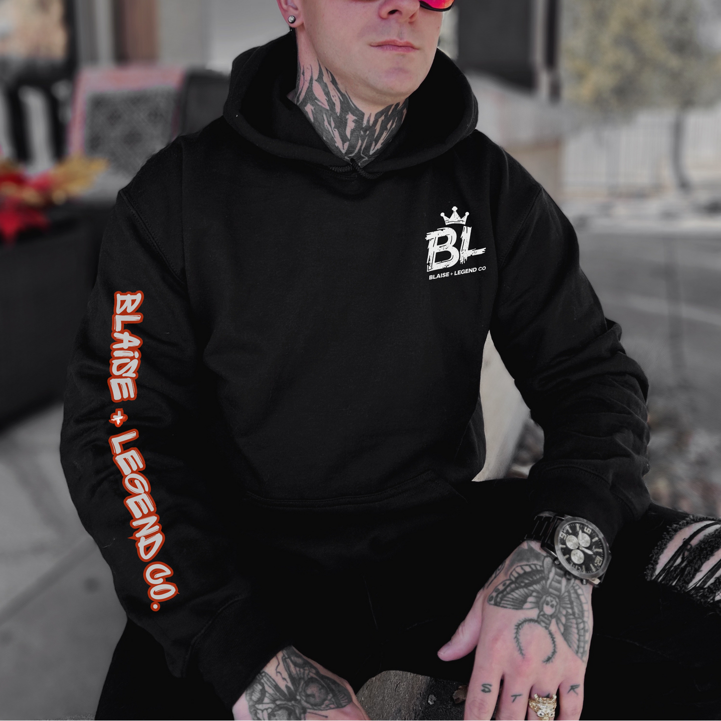 Burning Bridges hoodie with skeleton hand making rock symbol, surrounded by flames, 'Fueled by Fire' slogan, and Blaise + Legend Co. logo on sleeve. Edgy, bold design for men and women.