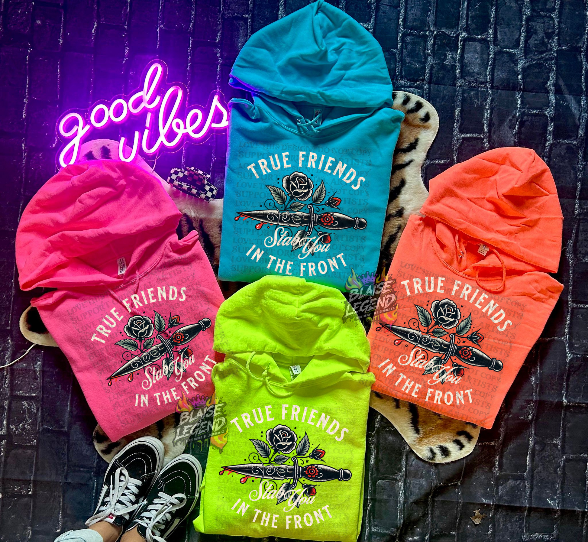 Pink, orange, green, and blue neon hoodies with dagger and rose graphic