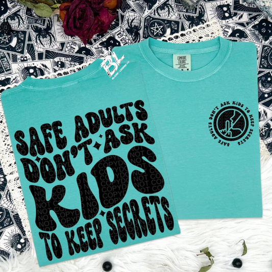 Comfort Colors short sleeve shirt in teal with bold black text that reads 'Safe Adults Don’t Ask Kids to Keep Secrets' and a circular logo emphasizing child safety.