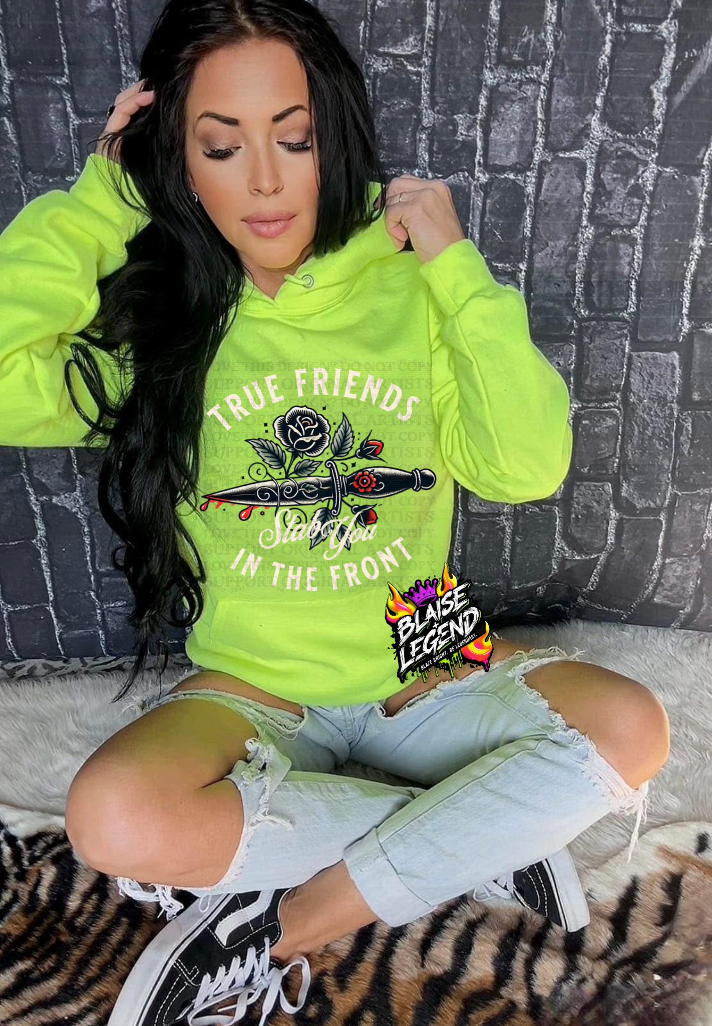 Woman wearing a neon green hoodie featuring bold dagger and rose artwork