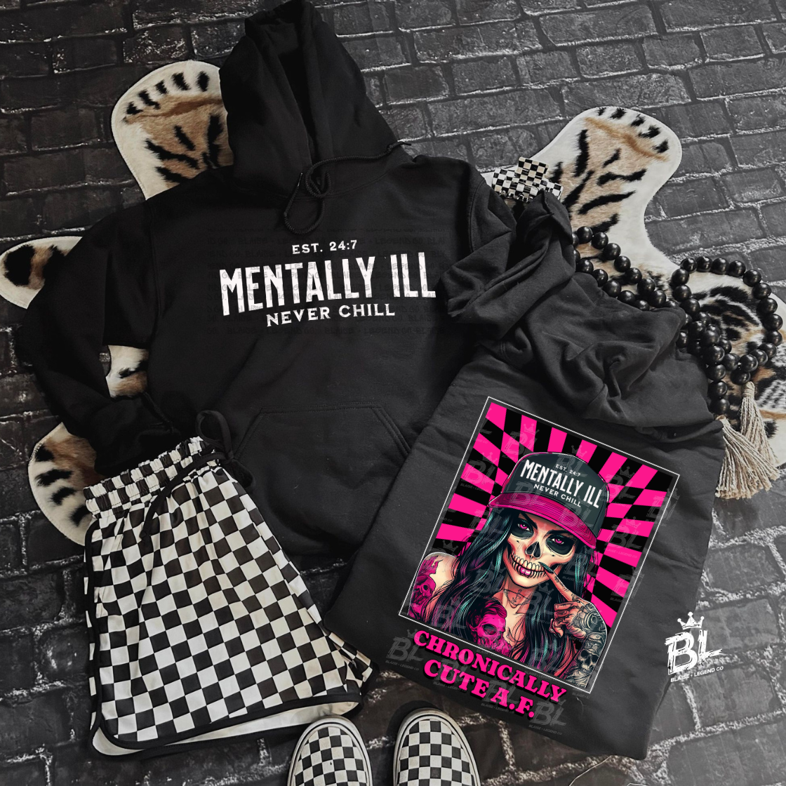 Black hoodie with 'Mentally Ill Never Chill' bold white text, featuring edgy streetwear design, rebellious alternative fashion statement.