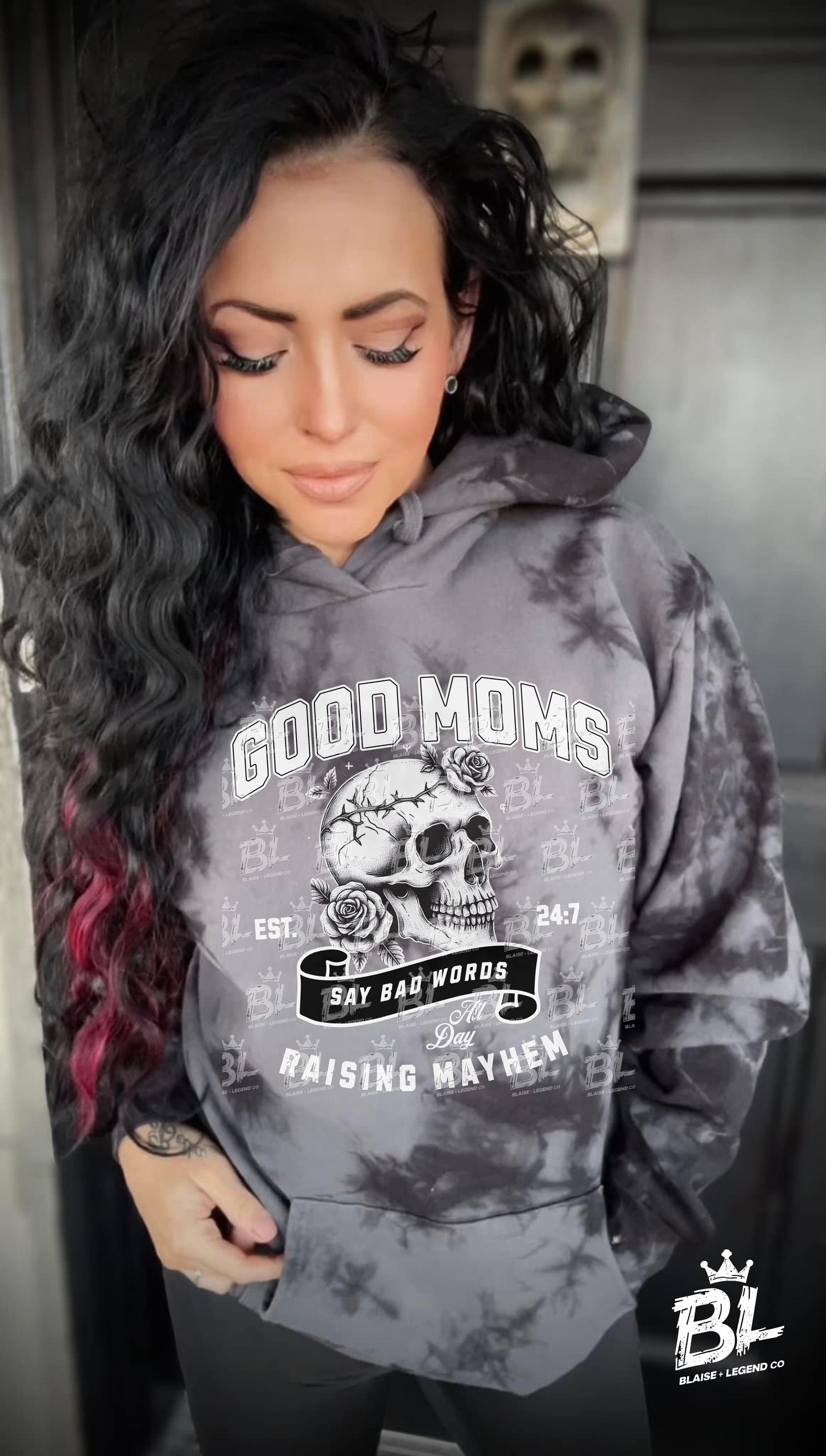 Black ice dyed women's hoodie with skull and roses graphic and 'Good Moms Say Bad Words' and 'Raising Mayhem' text